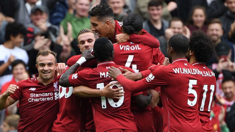 Liverpool's German-born Cameroonian defender Joel Matip celebrates with teammates after scoring the team's second goal during the English Premier League football match between Liverpool and Southampton at Anfield in Liverpool, north west England on September 22, 2018.