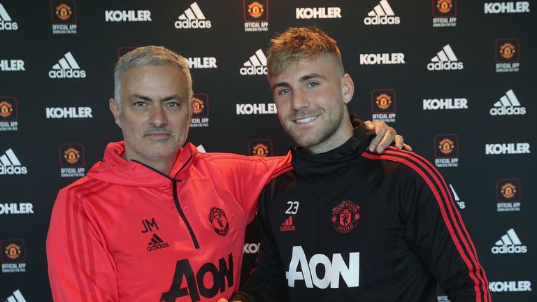 Luke Shaw shakes hands with Jose Mourinho after signing a new long-term contract with Manchester United