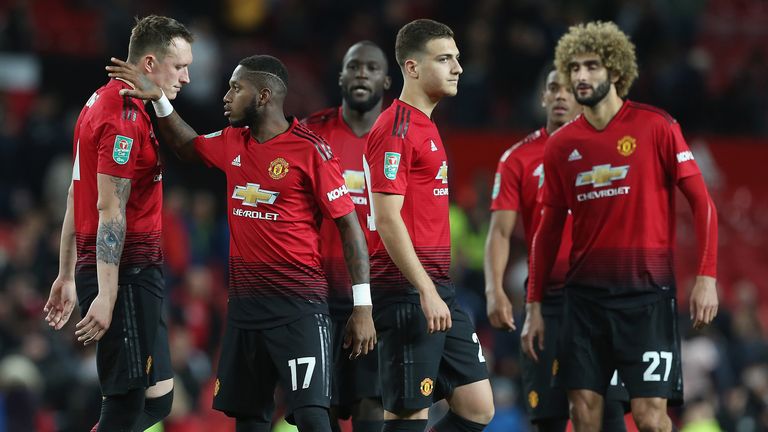 Phil Jones of Manchester United is consoled by Fred after missing a penalty during a shoot out during the Carabao Cup Third Round match between Manchester United and Derby County at Old Trafford on September 25, 2018 in Manchester, England. 