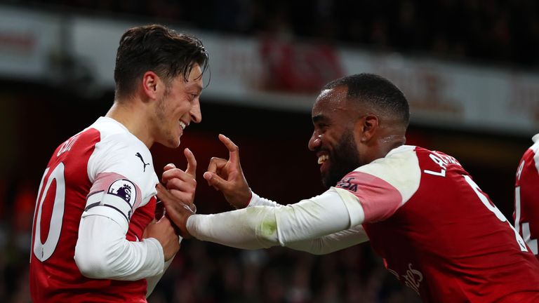 Mesut Ozil celebrates after stroking home Arsenal's equaliser