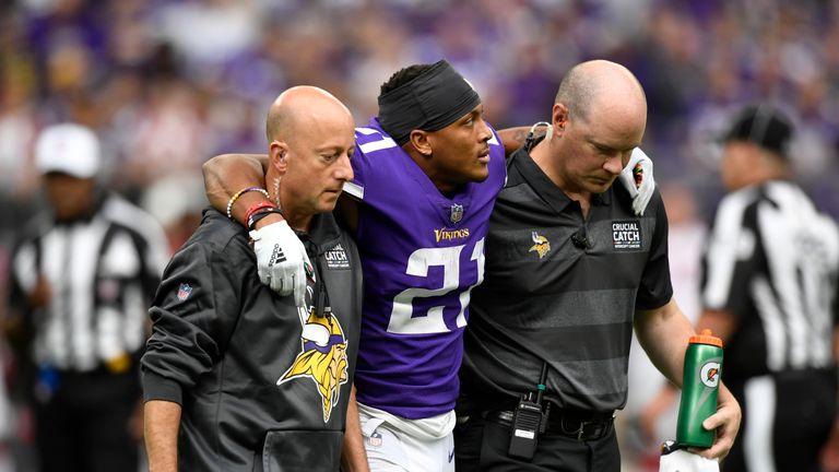 Mike Hughes is helped off the field against the Arizona Cardinals