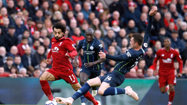 Mohamed Salah is tackled by Aymeric Laporte