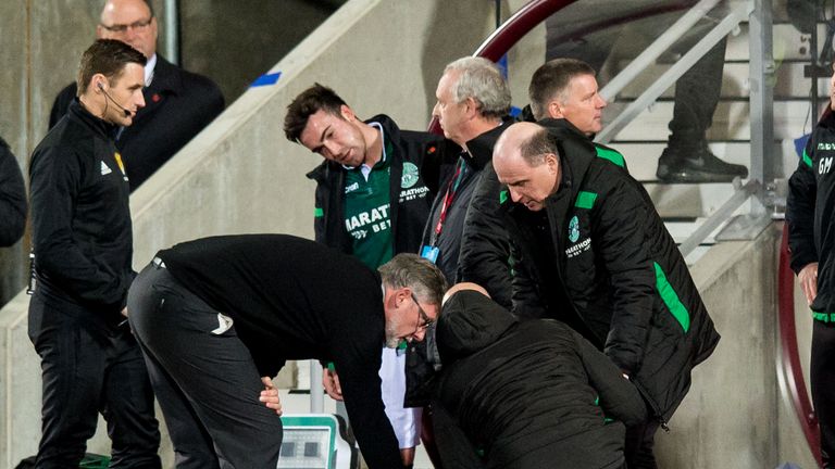 Hearts manager Craig Levein consoles Hibernian manager Neil Lennon after appearing to be struct by an object from the crowd