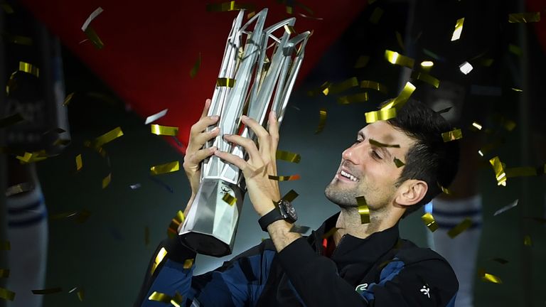 Serbia's Novak Djokovic holds the trophy after winning his men's final singles match against Croatia's Borna Coric at the Shanghai Masters tennis tournament in Shanghai on October 14, 