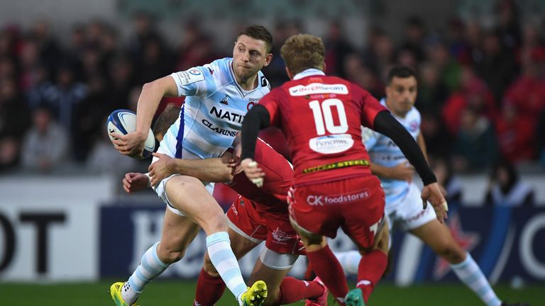  Racing fly-half Finn Russell offloads in the tackle