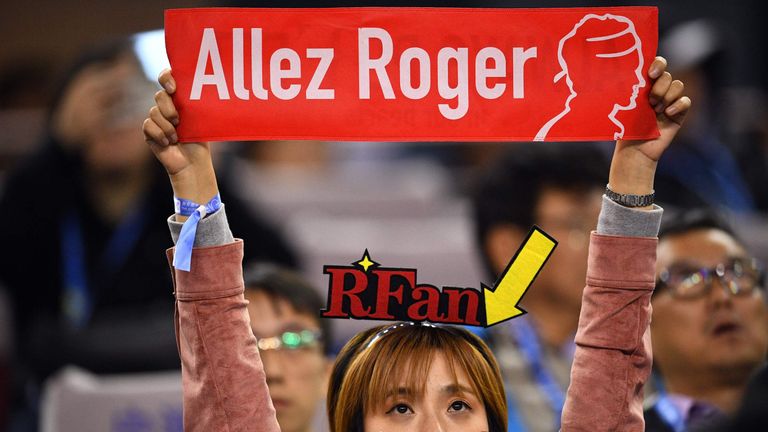 A supporter of Roger Federer of Switzerland holds a sign 'allez Roger' during his men's singles quarter-final match against Kei Nishikori of Japan at the Shanghai Masters tennis tournament on October 12, 2018. 