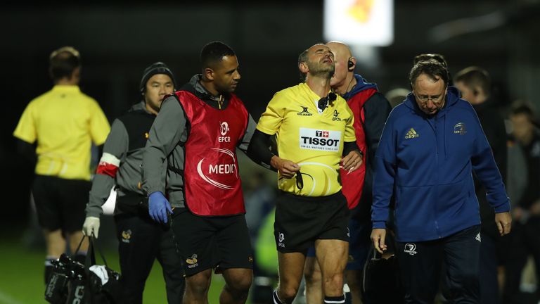 Referee Romain Poite is helped from the field after being injured during Leinster's Champions Cup clash with Wasps at the RDS