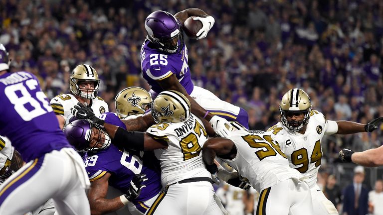 Latavius Murray #25 of the Minnesota Vikings leaps with the ball for a touchdown in the second quarter of the game against the New Orleans Saints at U.S. Bank Stadium on October 28, 2018 in Minneapolis, Minnesota