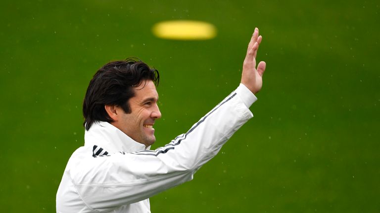 Santiago Solari waves to Real supporters