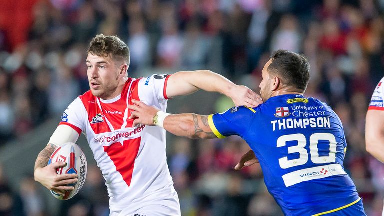 St Helens' Mark Percival fends off Warrington's Bodene Thompson