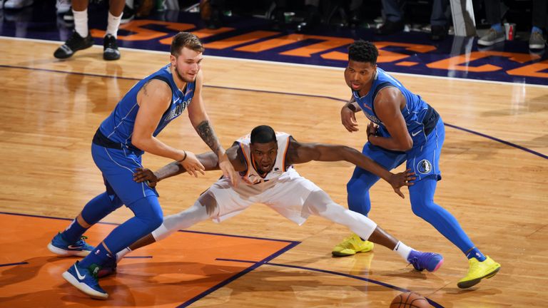 Josh Jackson #20 of the Phoenix Suns defends against Luka Doncic #77 and Dennis Smith Jr. #1 of the Dallas Mavericks on October 17, 2018 at Talking Stick Resort Arena in Phoenix, Arizona.