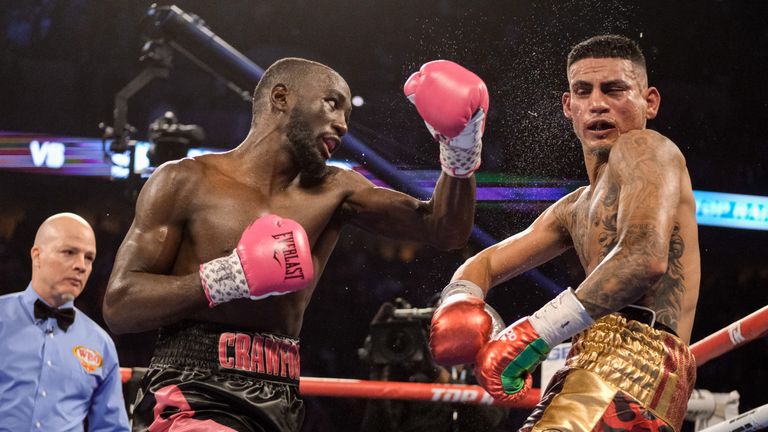 OMAHA, NE - OCTOBER 13:Jose Benavidez (red/yellow trunks) and Bud Crawford (black/pink trunks) exchange blows during their match at at CHI Health Center on October 13, 2018 in Omaha, Nebraska. Crawford won via TKO in the 12th round.. (Photo by Eric Francis/Getty Images)