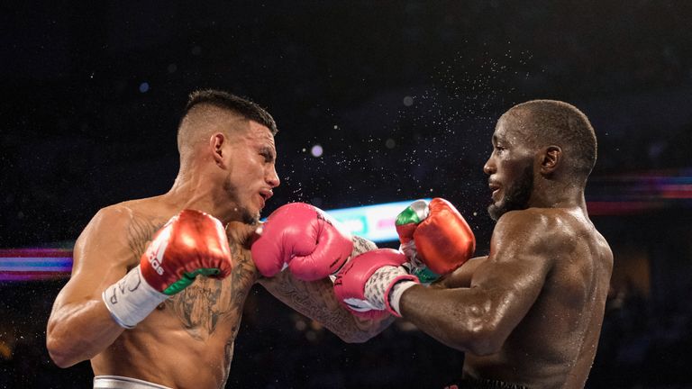 OMAHA, NE - OCTOBER 13:Jose Benavidez (red/yellow trunks) and Bud Crawford (black/pink trunks) exchange blows during their match at at CHI Health Center on October 13, 2018 in Omaha, Nebraska. Crawford won via TKO in the 12th round.. (Photo by Eric Francis/Getty Images)