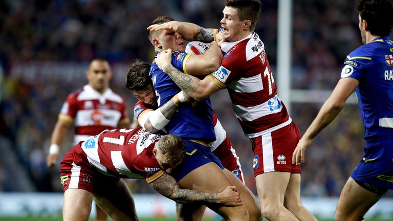 Warrington Wolves' Tom Lineham (centre right) is tackled by Wigan Warriors' John Bateman 