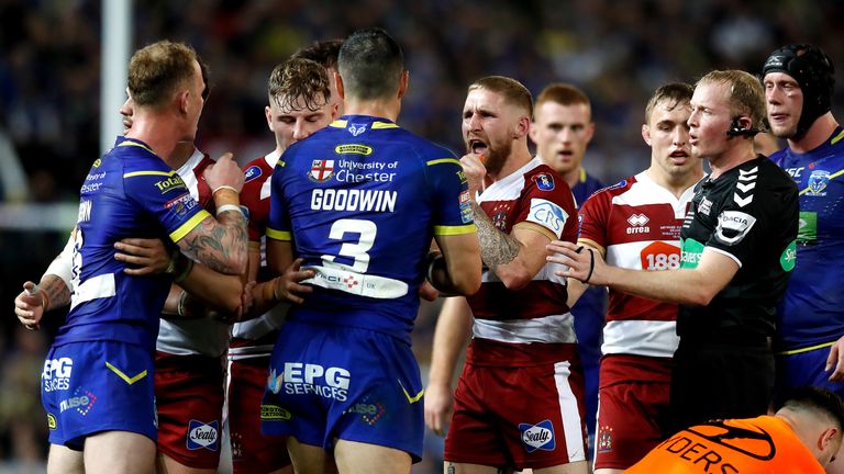 Wigan Warriors and Warrington Wolves players come together at the end of the first half of 2018 Super League Grand Final