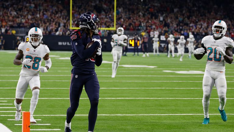 Will Fuller V #15 of the Houston Texans catches a touchdown pass defended by Bobby McCain #28 and Reshad Jones #20 of the Miami Dolphins in the third quarter at NRG Stadium on October 25, 2018 in Houston, Texas.