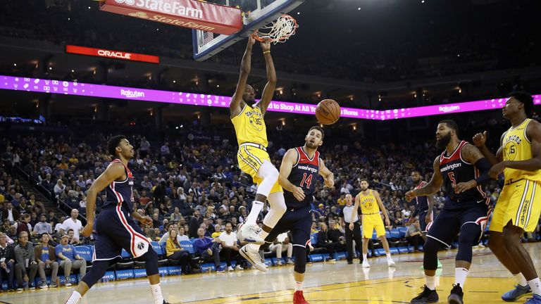 Kevin Durant #35 of the Golden State Warriors dunks the ball on Jason Smith #14 of the Washington Wizards at ORACLE Arena on October 24, 2018 in Oakland, California.