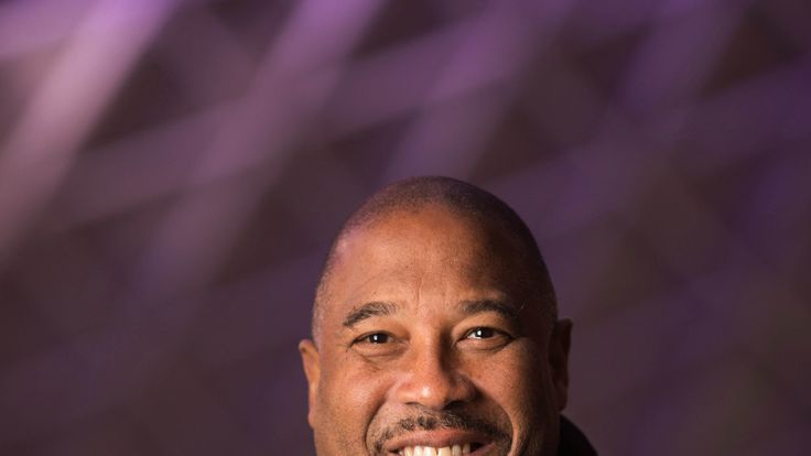 Former Liverpool FC player John Barnes teaches commuters how to perfect striking a football at a pop-up event hosted by Western Union at Kings Cross station in London.