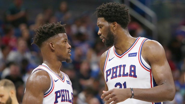 Jimmy Butler chats with team-mate Joel Embiid