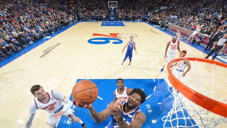 Joel Embiid swoops to score against the New York Knicks