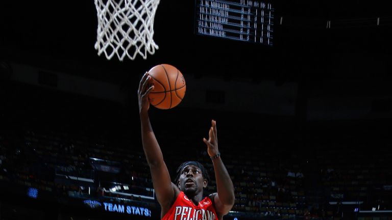 Jrue Holiday scores with a lay-up against Washington