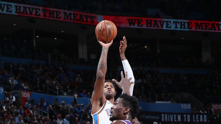 Paul George shoots over DeAndre Ayton