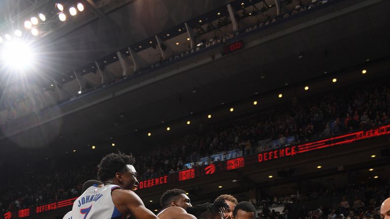 Reggie Bullock is mobbed by team-mates after his game-winning shot