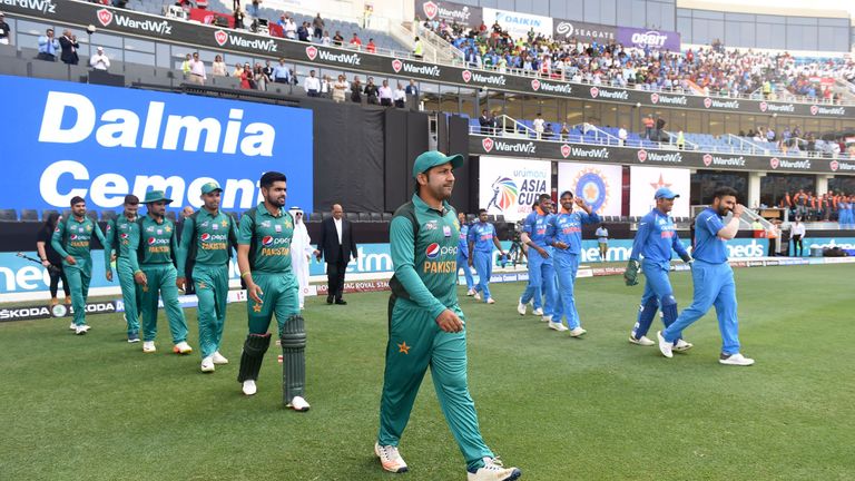 Indian and Pakistan (L) players line up before the start of the one day international (ODI) Asia Cup cricket match between Pakistan and India at the Dubai International Cricket Stadium in Dubai on September 19, 2018. 