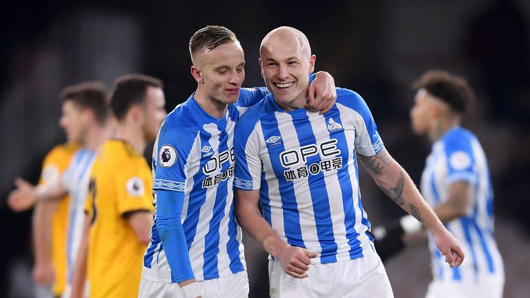 Florent Hadergjonaj and Aaron Mooy of Huddersfield celebrate victory following the Premier League match between Wolverhampton Wanderers and Huddersfield Town at Molineux on November 25, 2018 in Wolverhampton, United Kingdom