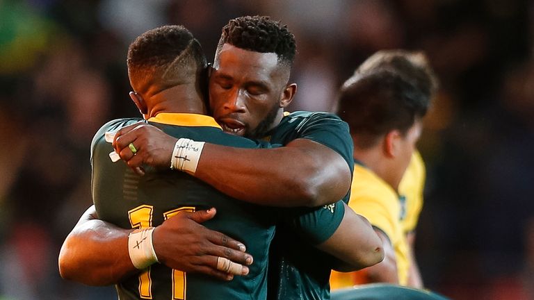 South Africa's winger Aphiwe Dyantyi (L) and South Africa's loose forward Siya Kolisi celebrate after winning the Rugby Championship match between South Africa and Australia at Nelson Mandela Bay Stadium in Port Elizabeth, South Africa, on September 29, 2018.