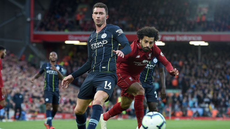 Manchester City's French defender Aymeric Laporte (L) vies with Liverpool's Egyptian midfielder Mohamed Salah during the English Premier League football match between Liverpool and Manchester City at Anfield in Liverpool, north west England on October 7, 2018.