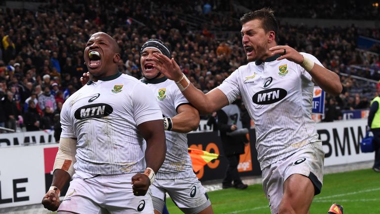 South Africa's hooker Bongi Mbonambi (L) celebrates with South Africa's winger Cheslin Kolbe (C) and South Africa's fly-half Handre Pollard (R) after scoring a try during the international rugby union test match between France and South Africa at the Stade de France in Saint-Denis, north of Paris, on November 10, 2018. 