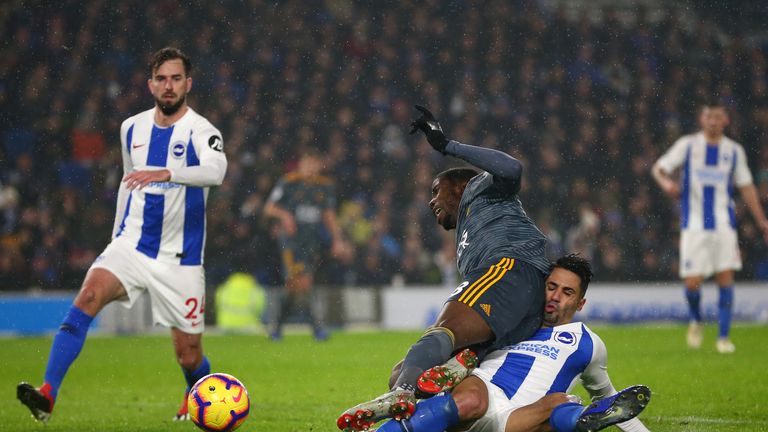 Beram Kayal brings down Kelechi Iheanacho to concede a penalty in the closing stages of Brighton's match with Leicester