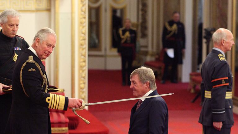 Liverpool legend Sir Kenny Dalglish is knighted by the Prince of Wales at Buckingham Palace