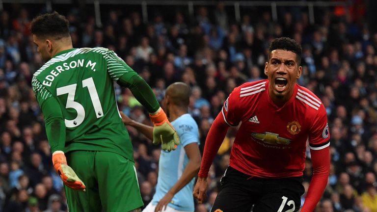 Manchester United&#39;s English defender Chris Smalling (R) celebrates scoring their third goal during the English Premier League football match between Manchester City and Manchester United at the Etihad Stadium in Manchester, north west England, on April 7, 2018.