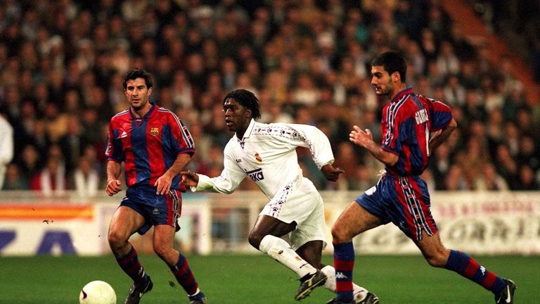 Clarence Seedorf sprints past Pep Guardiola during his time at Real Madrid