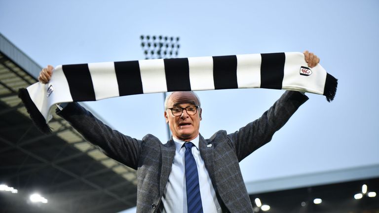 Fulham's new manager Claudio Ranieri poses with a team scarf on the pitch at Craven Cottage