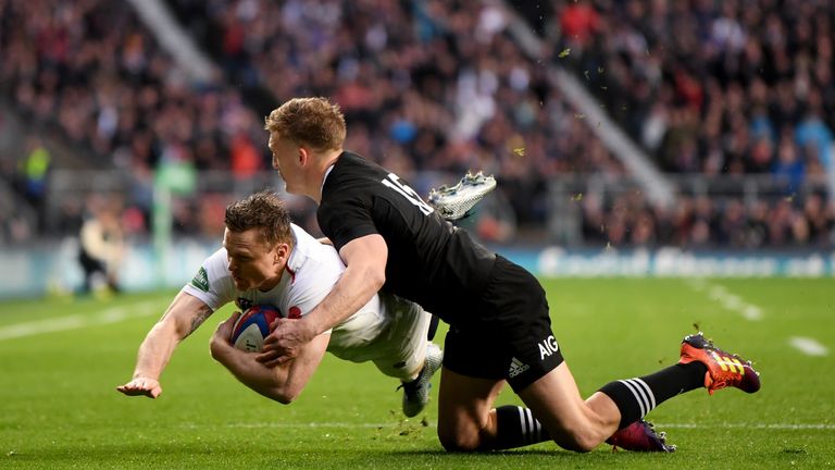 Chris Ashton scores a try despite attention from Damian McKenzie during the Quilter International match between England and New Zealand at Twickenham Stadium on November 10, 2018 in London, United Kingdom.