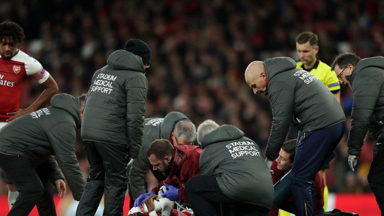 Referee Gediminas Mazeika stands over Danny Welbeck of Arsenal as he is injured during the UEFA Europa League Group E match between Arsenal and Sporting CP at Emirates Stadium on November 8, 2018 in London, United Kingdom.