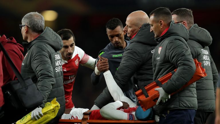 Referee Gediminas Mazeika stands over Danny Welbeck of Arsenal as he is injured during the UEFA Europa League Group E match between Arsenal and Sporting CP at Emirates Stadium on November 8, 2018 in London, United Kingdom.