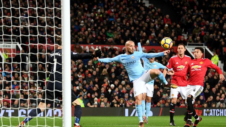 David Silva of Manchester City scores the first Manchester City goal past David De Gea of Manchester United during the Premier League match between Manchester United and Manchester City at Old Trafford on December 10, 2017 in Manchester, England. (