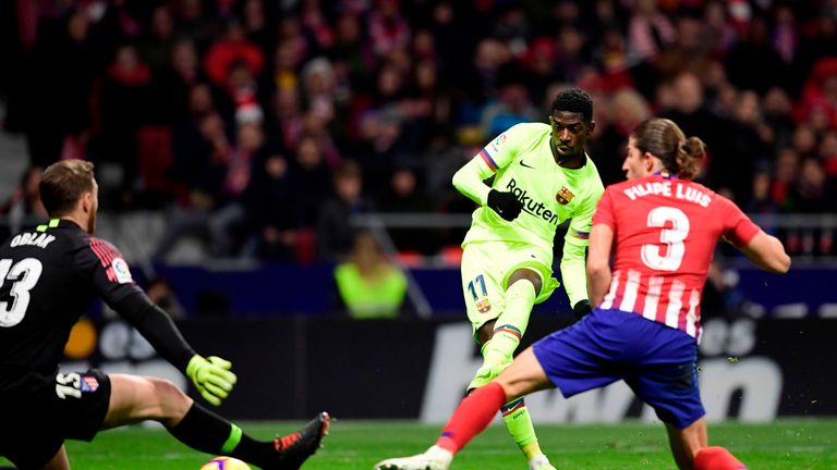 Dembele strikes the ball past the onsrushing Jan Oblak