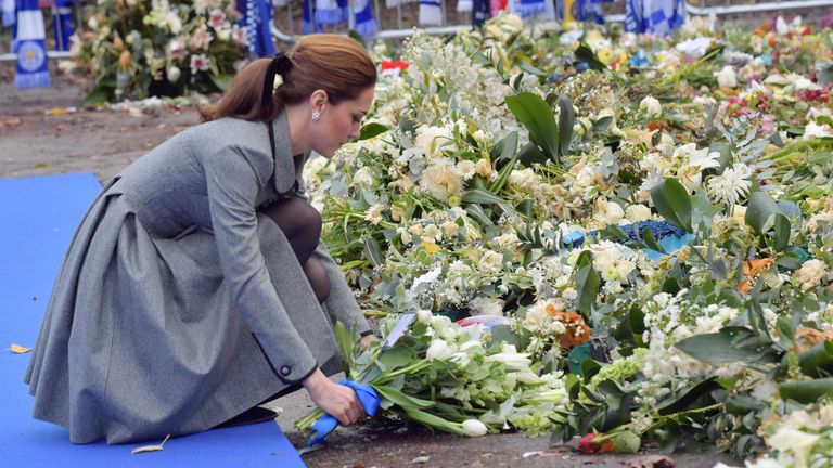 Catherine, Duchess of Cambridge lays flowers in tribute to victims of the helicopter crash at Leicester City's King Power Stadium
