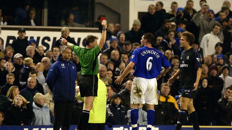 Referee Eddie Wolstenholme shows a red card to David Unsworth of Everton after a fight with Jesper Gronkjaer of Chelsea during the FA Barclaycard Premiership match between Everton and Chelsea held on December 7, 2002