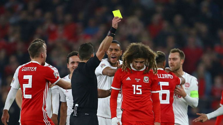 Wales&#39; defender Ethan Ampadu is booked for his challenge on Denmark&#39;s Kasper Dolberg 