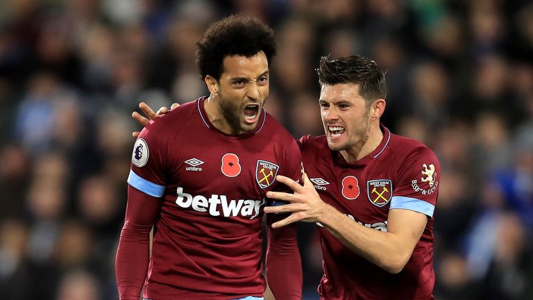 Felipe Anderson of West Ham United celebrates with teammate Aaron Cresswell after scoring his team's first goal during the Premier League match between Huddersfield Town and West Ham United at the John Smith's Stadium on November 10, 2018 in Huddersfield, United Kingdom