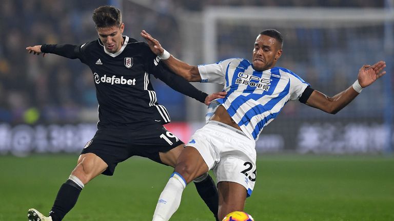 Fulham's Argentinian striker Luciano Vietto (L) vies with Huddersfield Town's Danish defender Mathias Jorgensen (R) during the English Premier League football match between Huddersfield Town and Fulham at the John Smith's stadium in Huddersfield, northern England on November 5, 2018. 