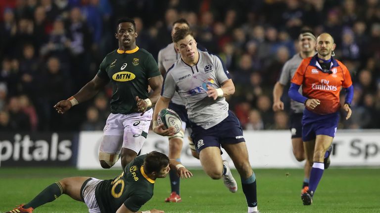 Huw Jones makes a fine break during a fiercely-competitive Test at Murrayfield