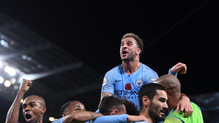 Ilkay Gundogan is mobbed by his Manchester City team-mates