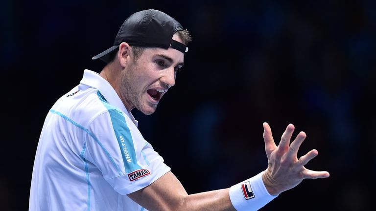 John Isner reacts against Serbia's Novak Djokovic during their men's singles round-robin match on day two of the ATP World Tour Finals tennis tournament at the O2 Arena in London on November 12, 2018.
